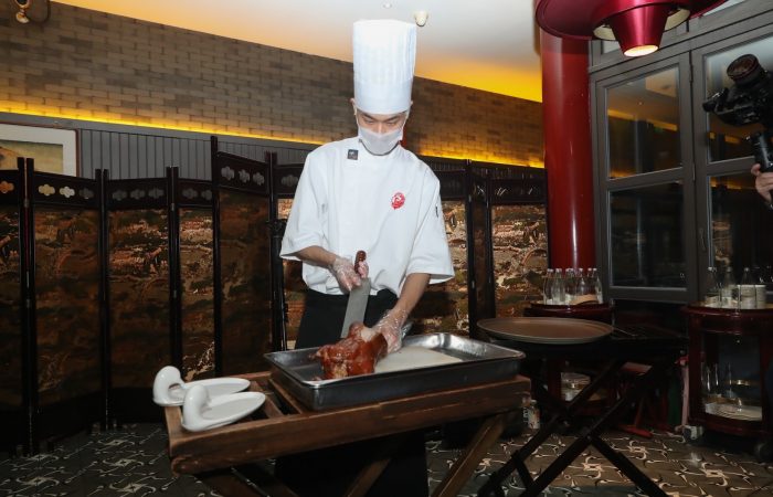 A chef prepares the Peking Duck