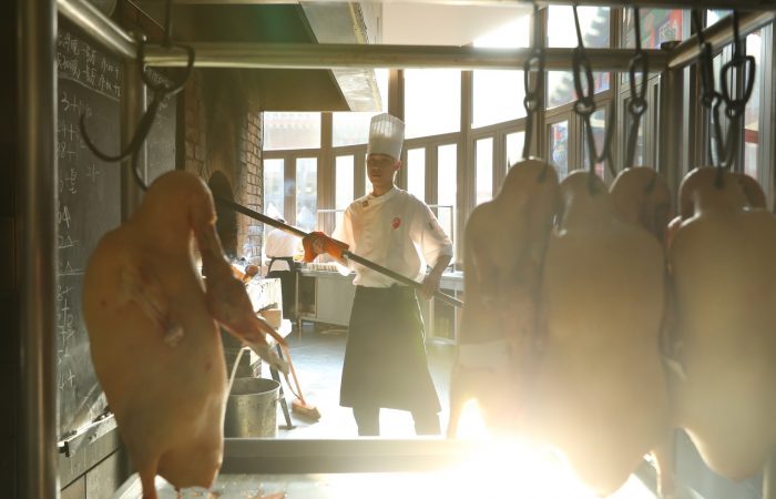 A chef roasting the Peking Duck